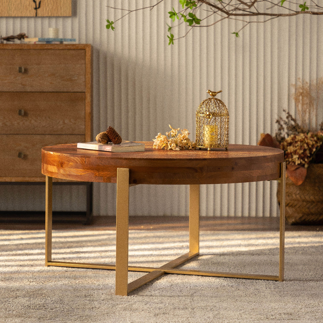 Wooden coffee table with gold legs in a living room setting
