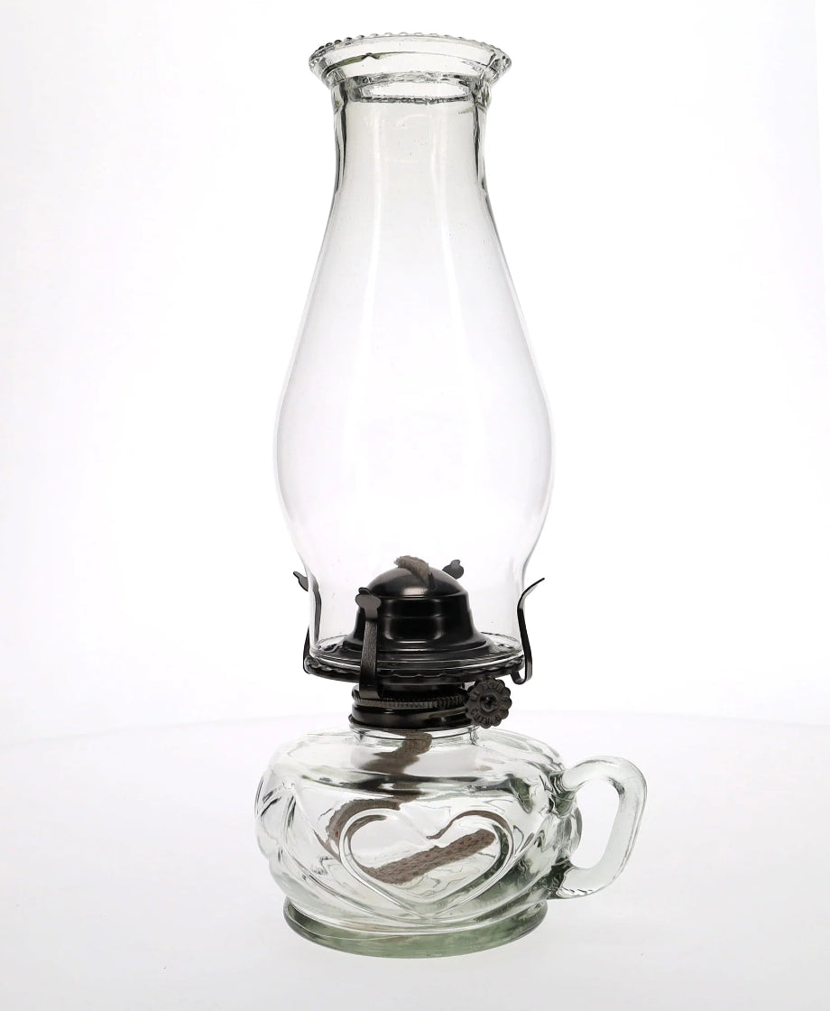Clear glass oil lamp on a white background