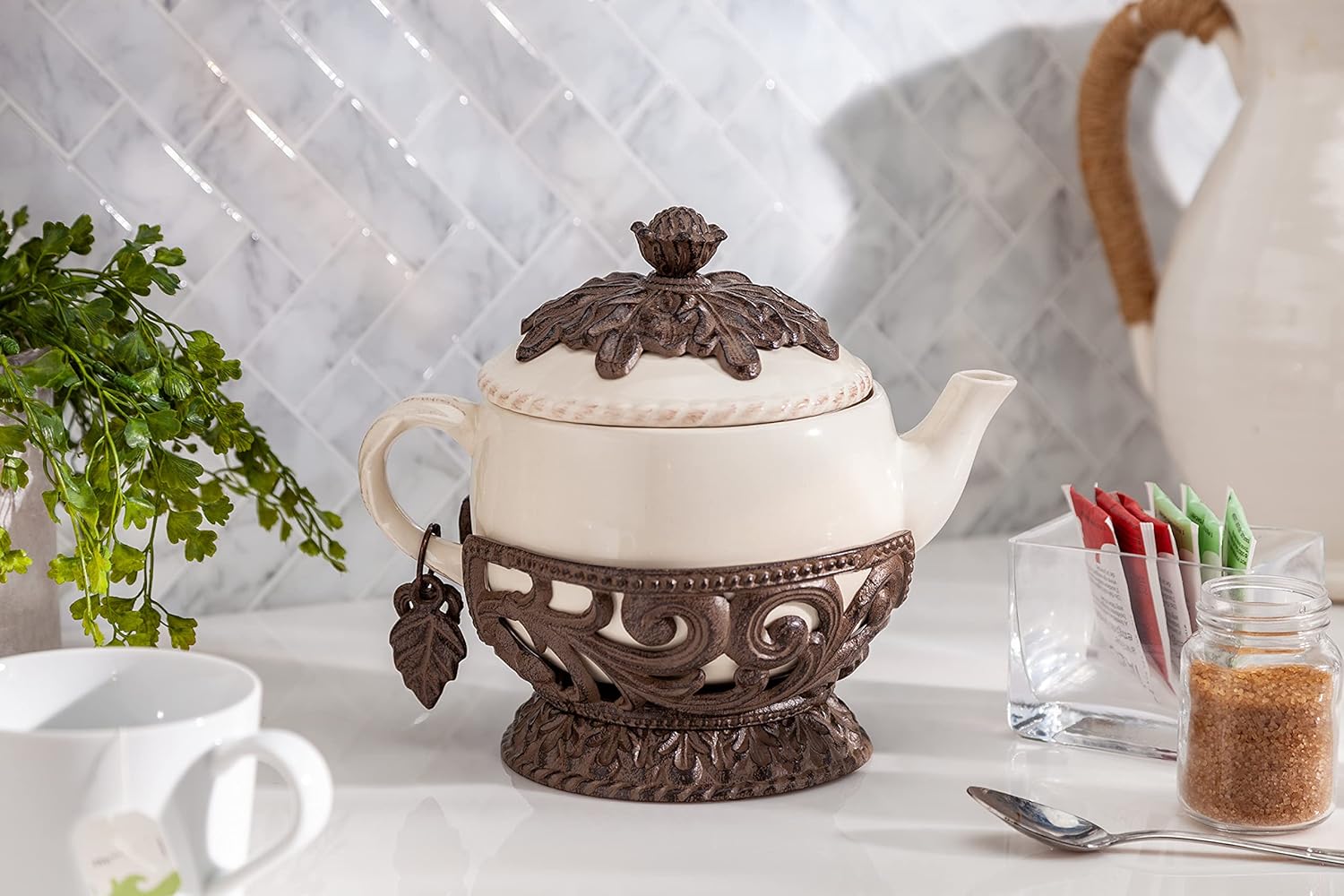 Cream Stoneware Teapot with Metal Acanthus Leaf Holder. -- Size: 9.5
