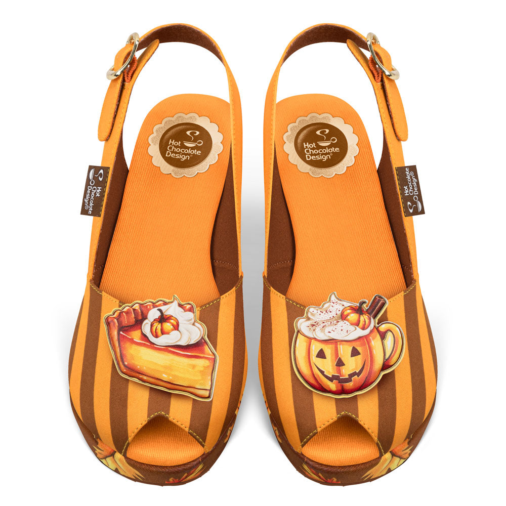 Pair of orange and brown striped sandals with Halloween-themed decorations on a white background.