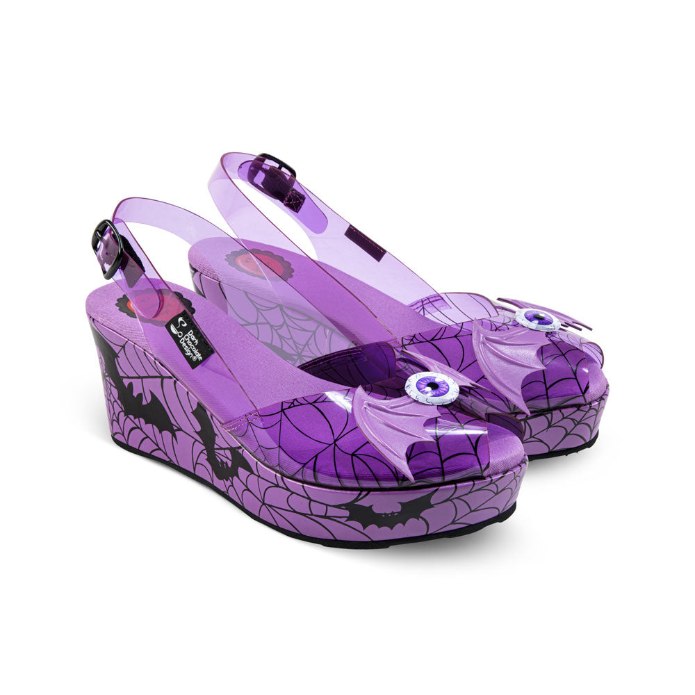 Purple platform shoes with spider web design on a white background