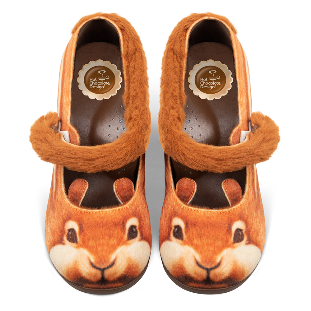 Pair of children's shoes with squirrel design on a white background