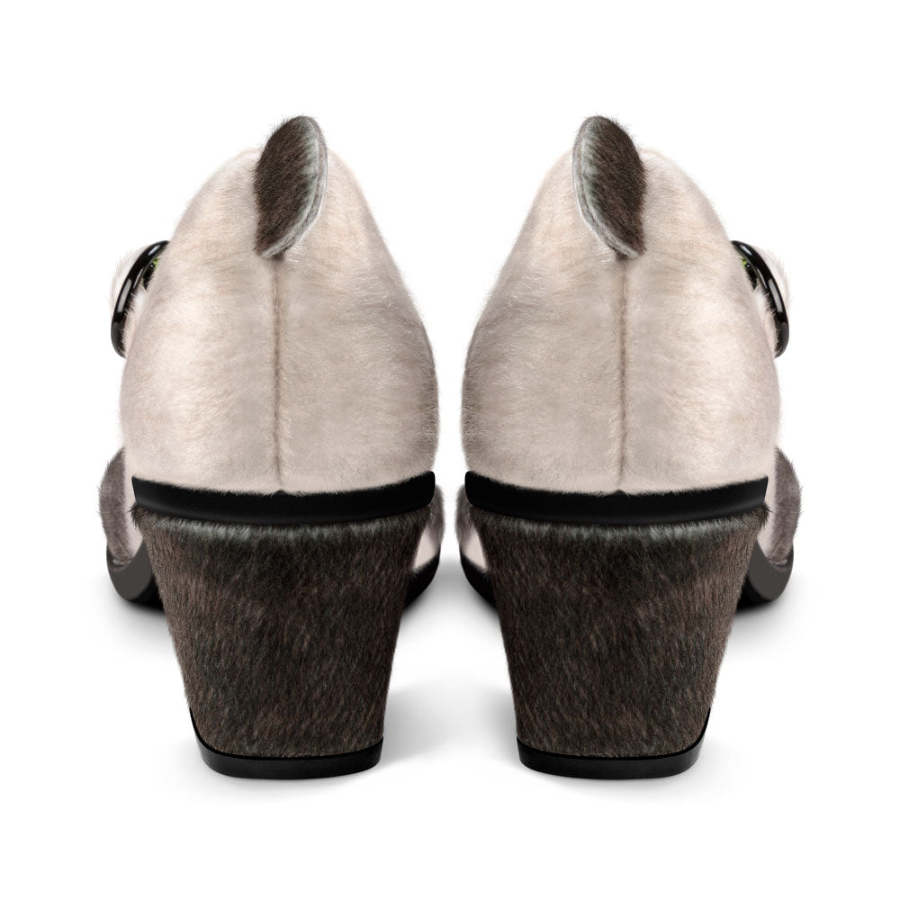 Pair of high-heeled shoes with a textured sole on a white background