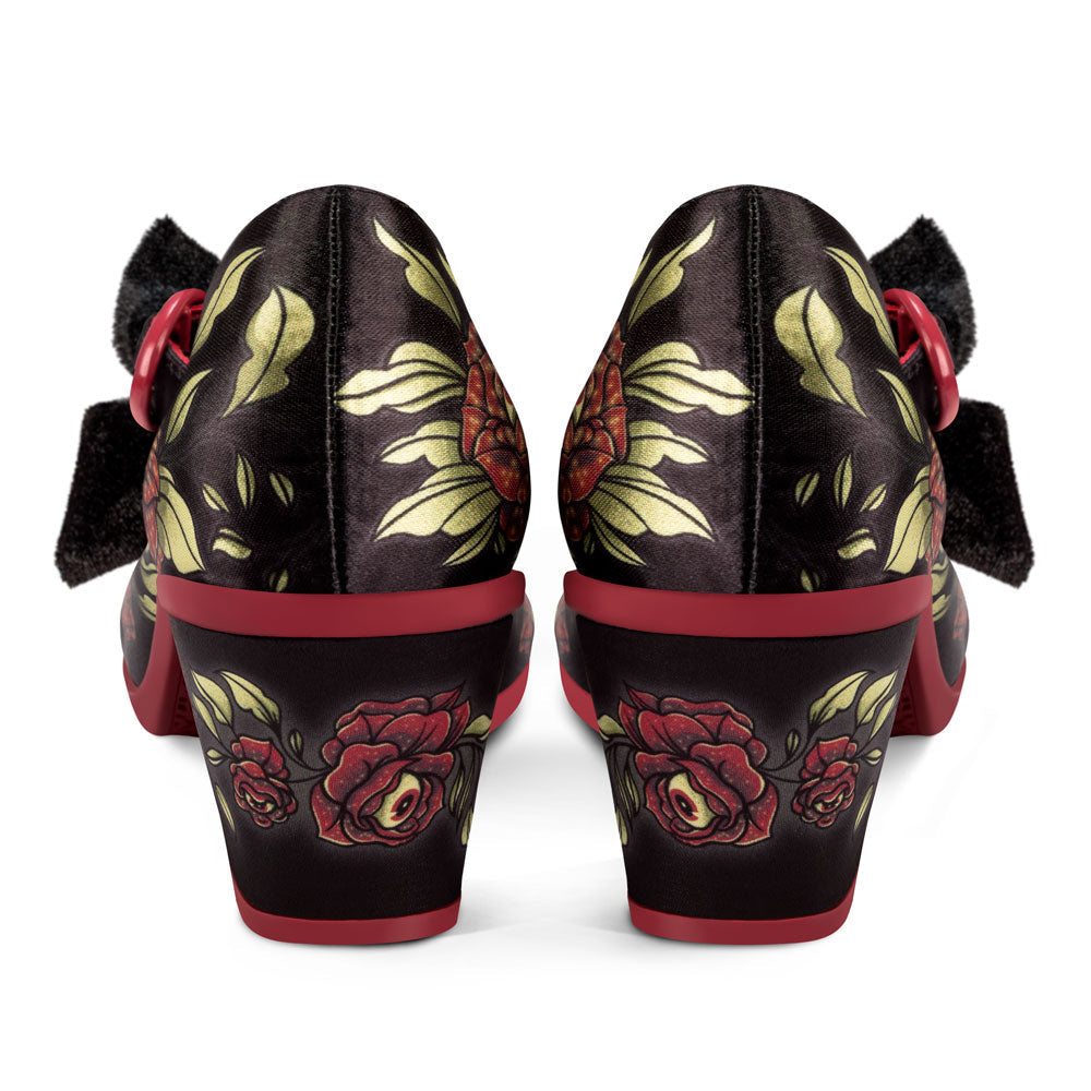 Pair of black shoes with red and gold floral patterns on a white background