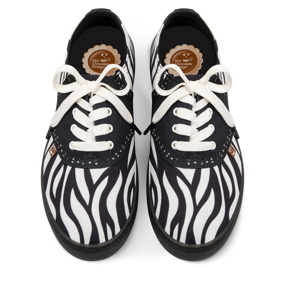 Hot Chocolate Design Black and white zebra-patterned shoes with white laces on a white background
