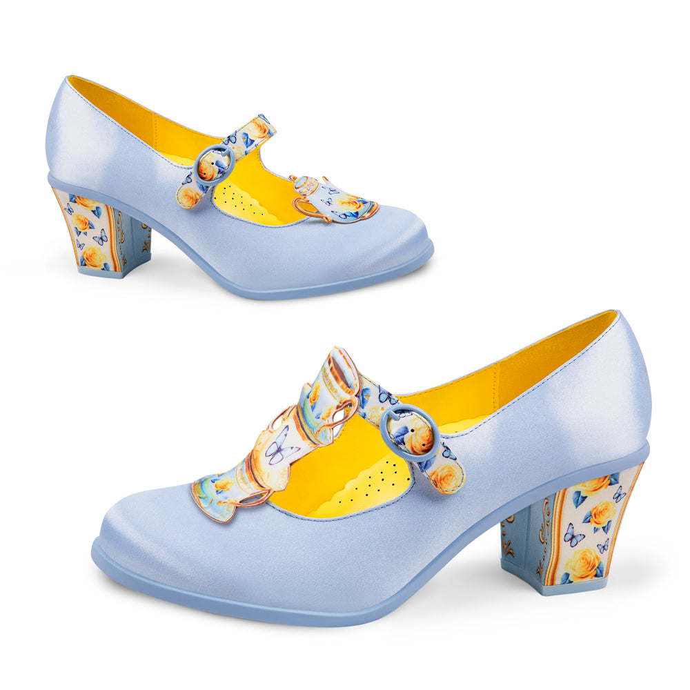 Pair of blue high-heeled shoes with yellow interior and decorative straps on a white background