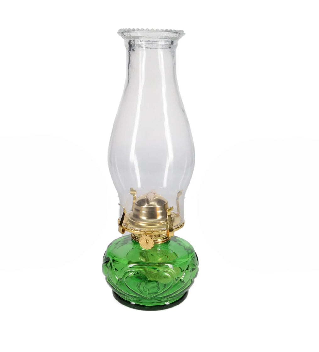 Vintage-style oil lamp with a green base and clear glass chimney on a white background