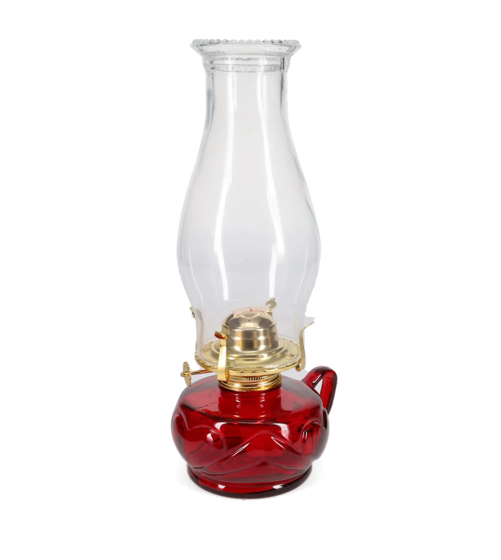 Red oil lamp with clear glass chimney on a white background