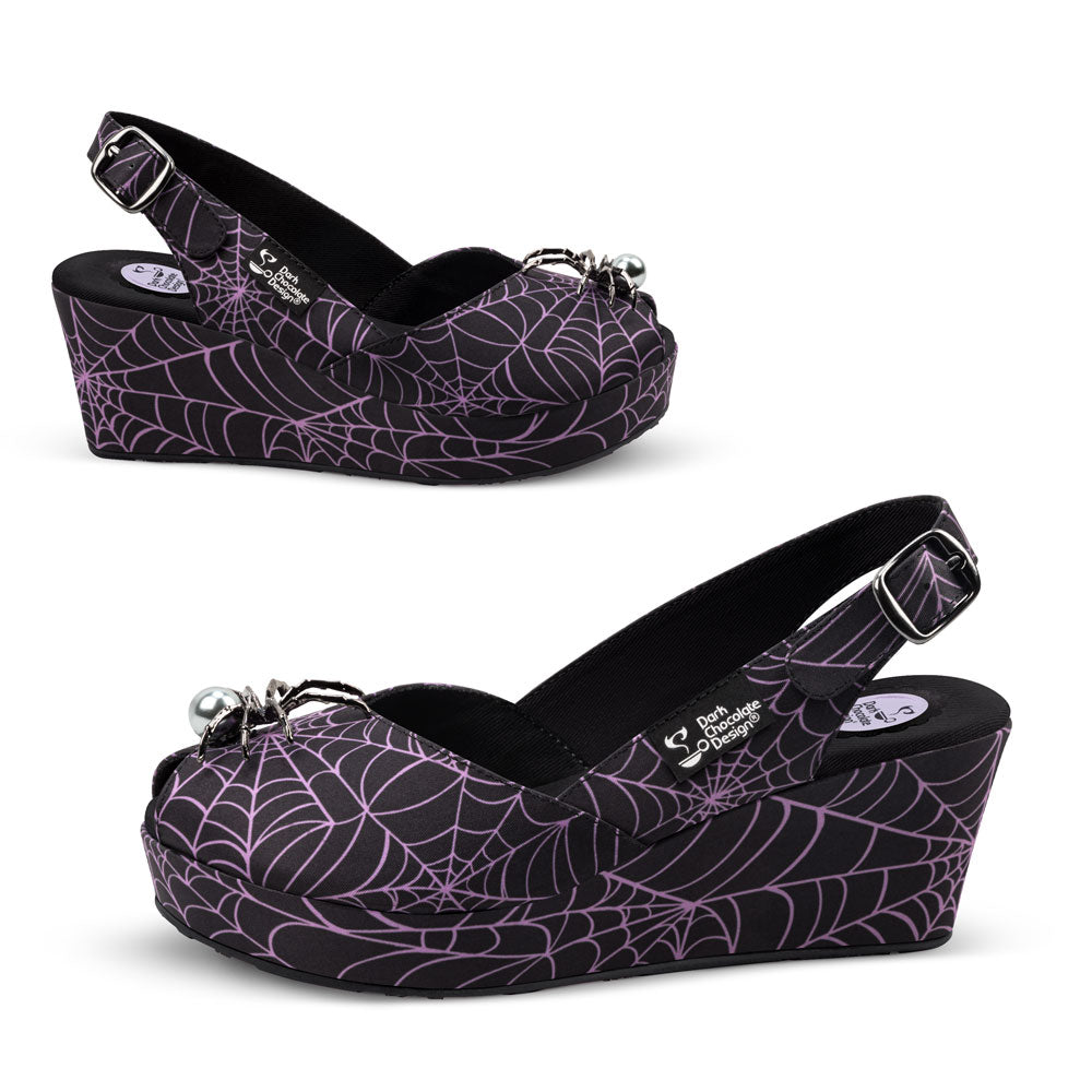 Purple spider web patterned wedge shoes on a white background