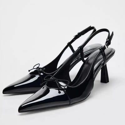 Black patent leather bow with pointed tip thin heel and a shallow strap for women's sandals