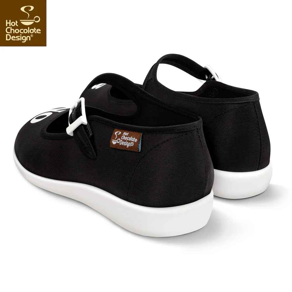 Black shoes with white soles on a white background, featuring Hot Chocolate Design logo.