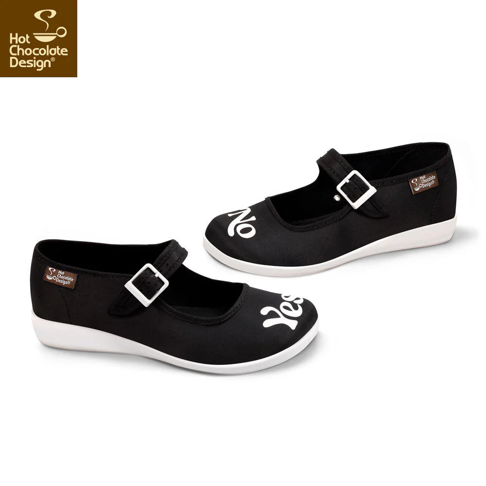 Black shoes with white soles and buckles on a white background, featuring Hot Chocolate Design logo.