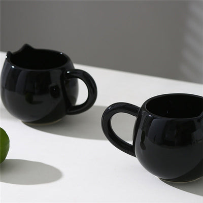 Adorable hand - painted cat - shaped ceramic mug, perfect for coffee or tea.