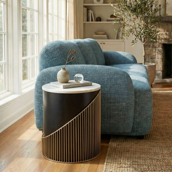 Blue armchair in a living room with a side table and decorative items.