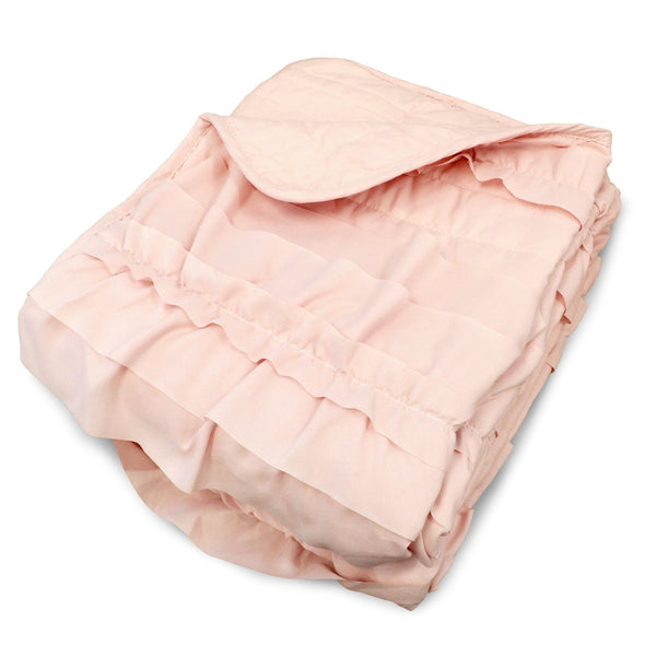 Folded pink comforter on a white background