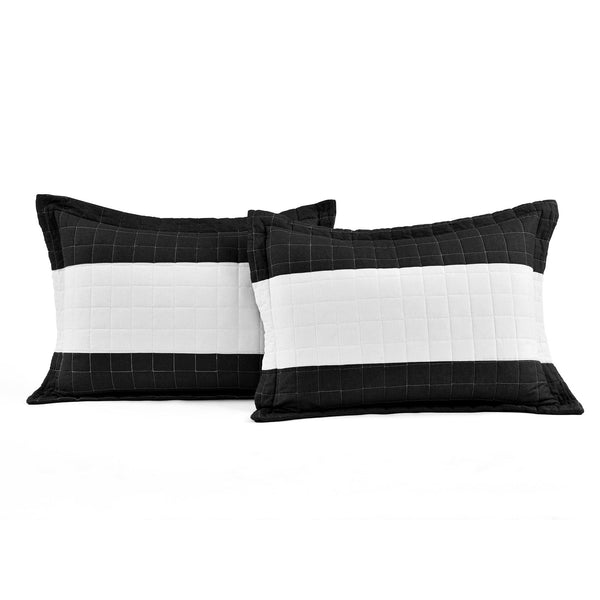 Two black and white checkered pillows on a white background