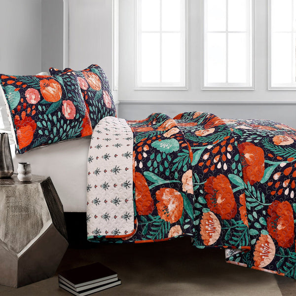 Floral and fruit patterned bedspread on a bed in a room with a window.
