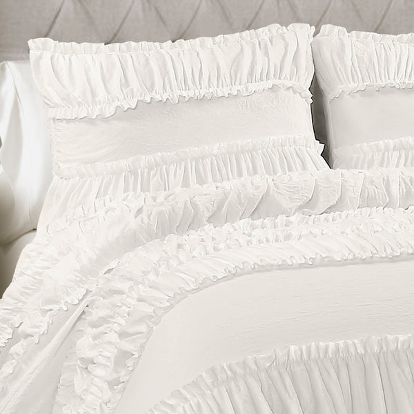 White ruffled pillows on a bed with a neutral background