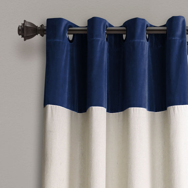 Navy blue and white curtain with a metal rod on a gray background