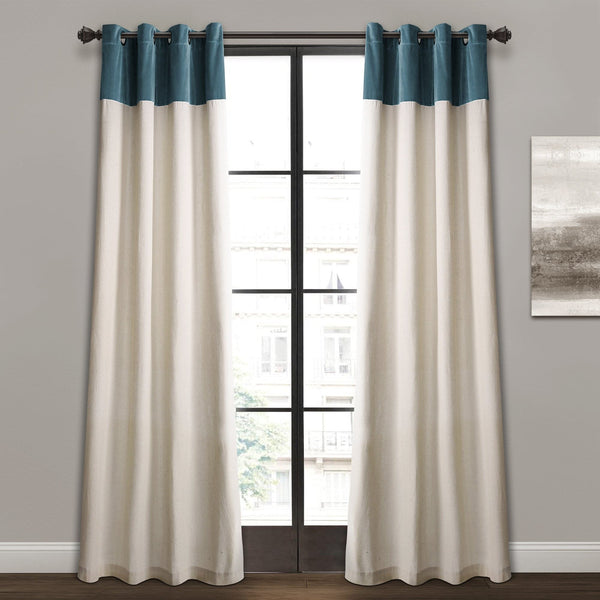 White curtains with blue top panels hanging in front of a window.