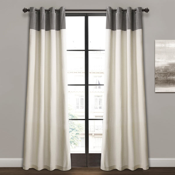 White curtains with gray top panels hanging in front of a window.