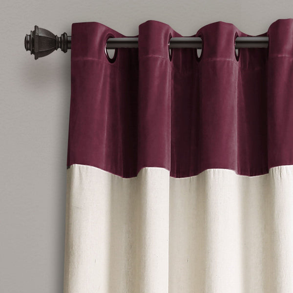Two-tone purple and white curtain with a rod on a plain background