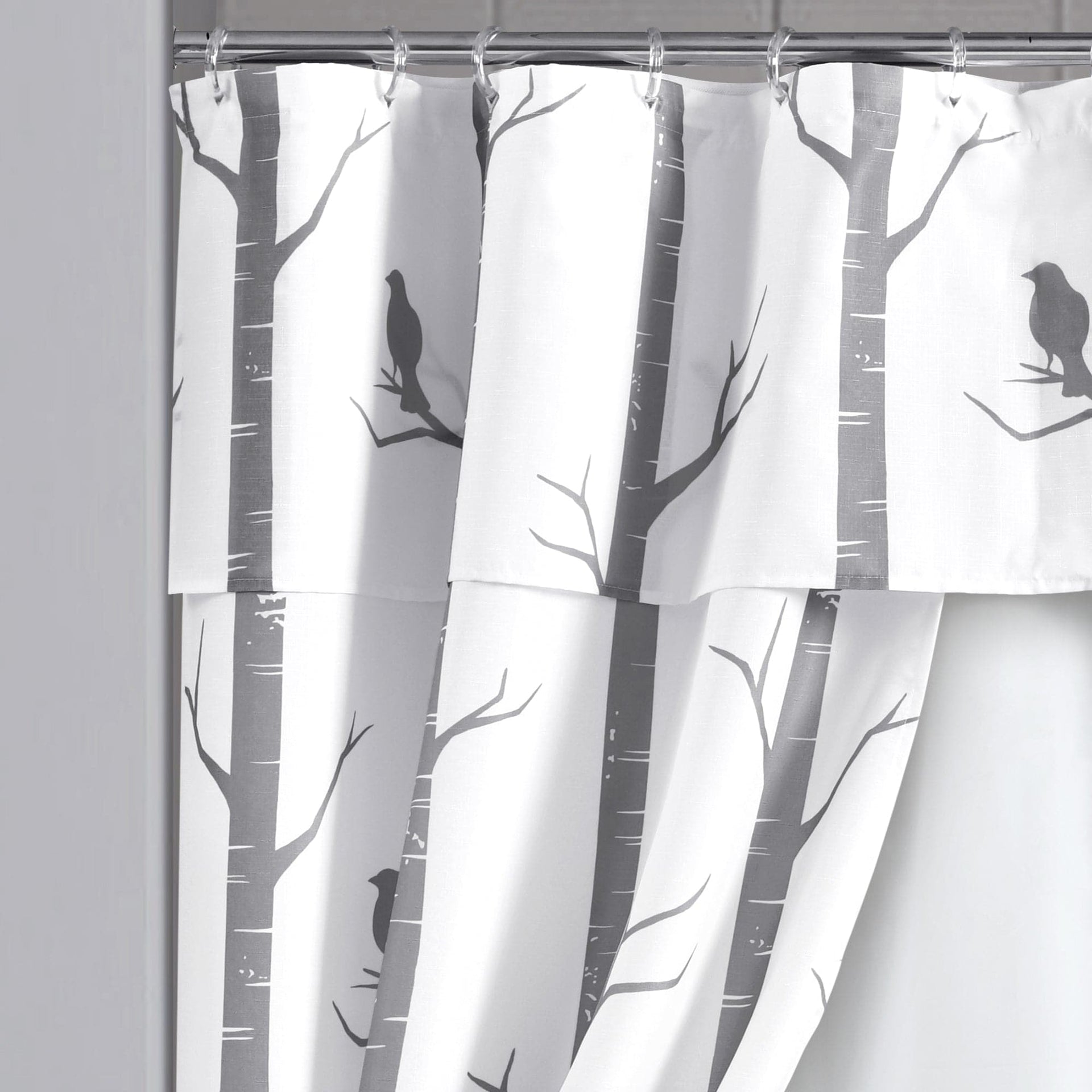 Shower curtain with tree and bird design on a white background