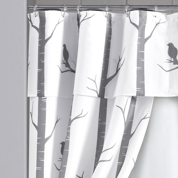 Shower curtain with tree and bird design on a white background