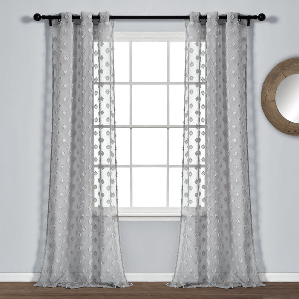 Sheer gray curtains with a subtle pattern hanging in front of a window.