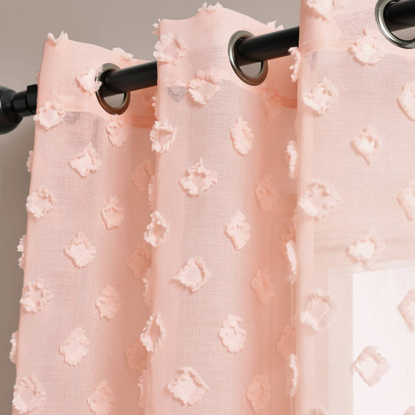Pink textured curtains with a black curtain rod on a neutral background