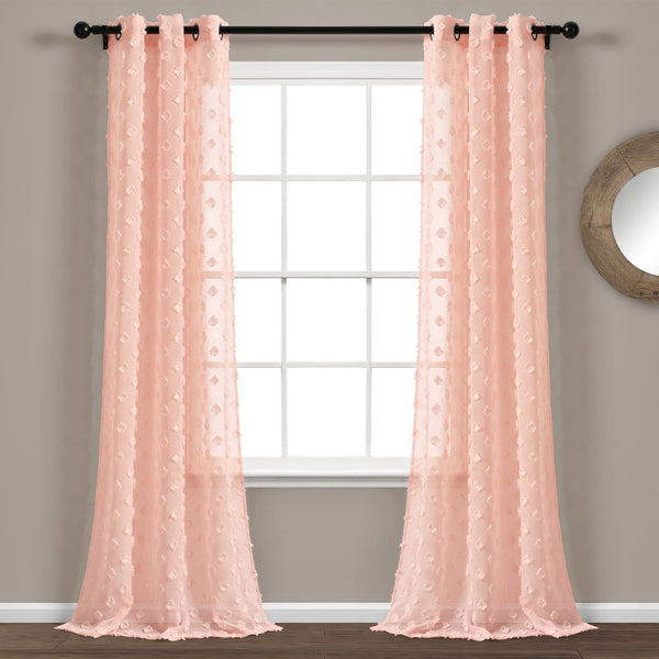 Pair of pink lace curtains hanging in front of a window.