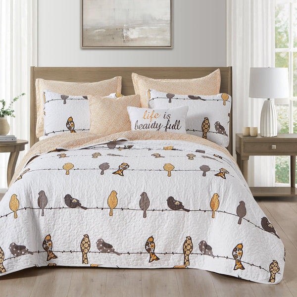 Bedding set with bird pattern on a bed in a bedroom setting