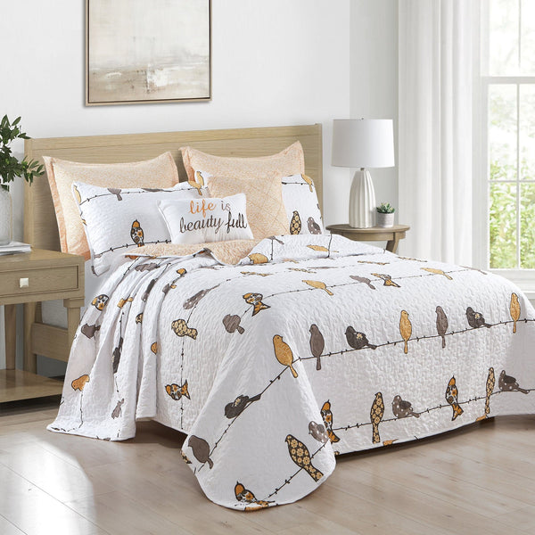 Bed with bird-themed bedding set in a bright bedroom