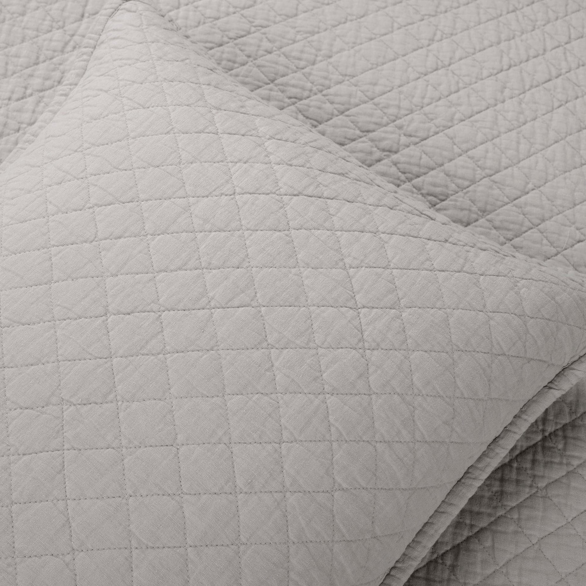 Close-up of a textured gray quilted blanket
