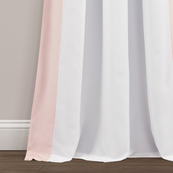 Pink and white curtains on a gray wall background
