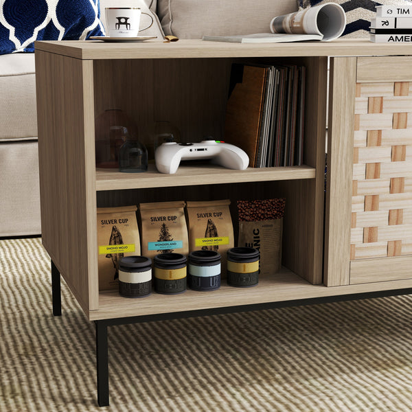 Wooden shelf with coffee bags, cups, and a gaming controller on a patterned rug.