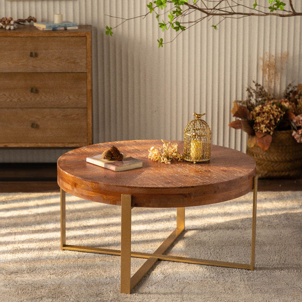 Wooden coffee table with gold legs in a room setting
