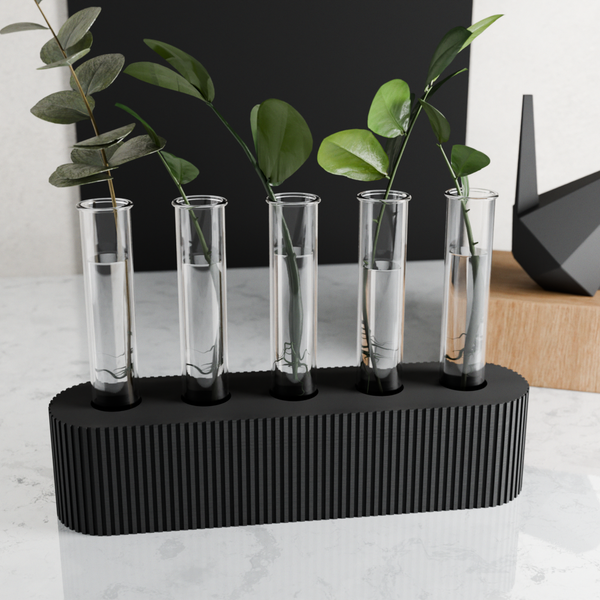 Set of five clear test tube-shaped vases on a black stand with green leaves.