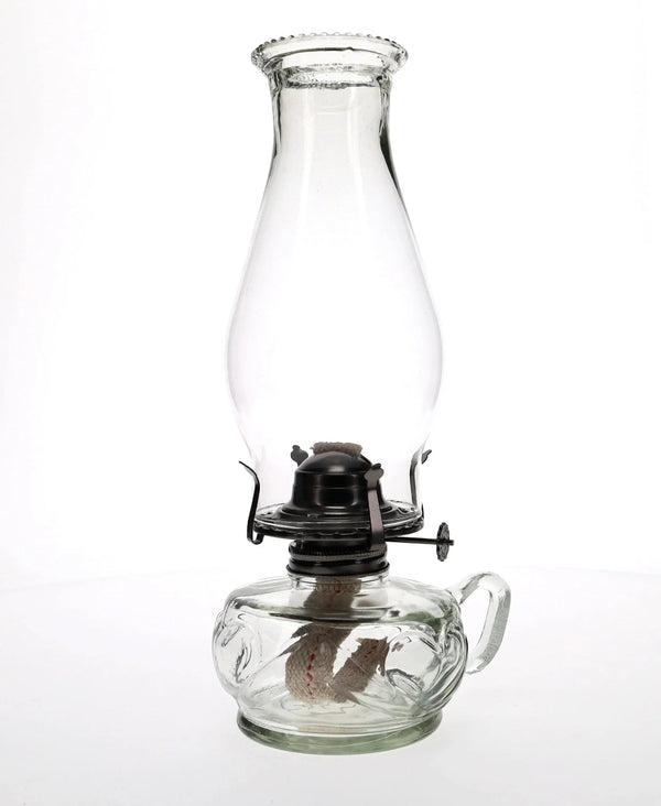 Clear glass oil lamp on a white background