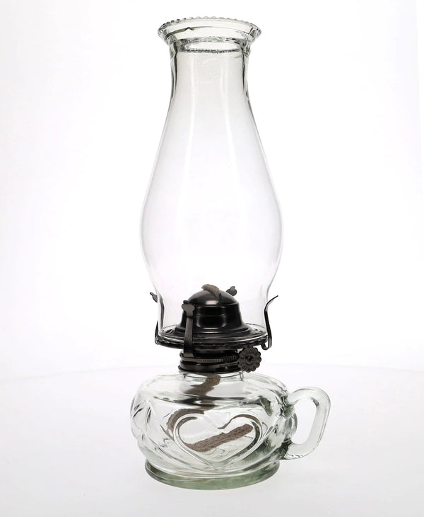 Clear glass oil lamp on a white background