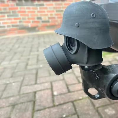 3D - printed trailer hitch cover with steel helmet and gas mask design. Protects the receiver tube from rusting.