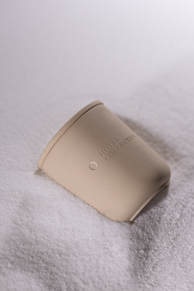 Beige container with 'Home Collection' text on a textured white surface