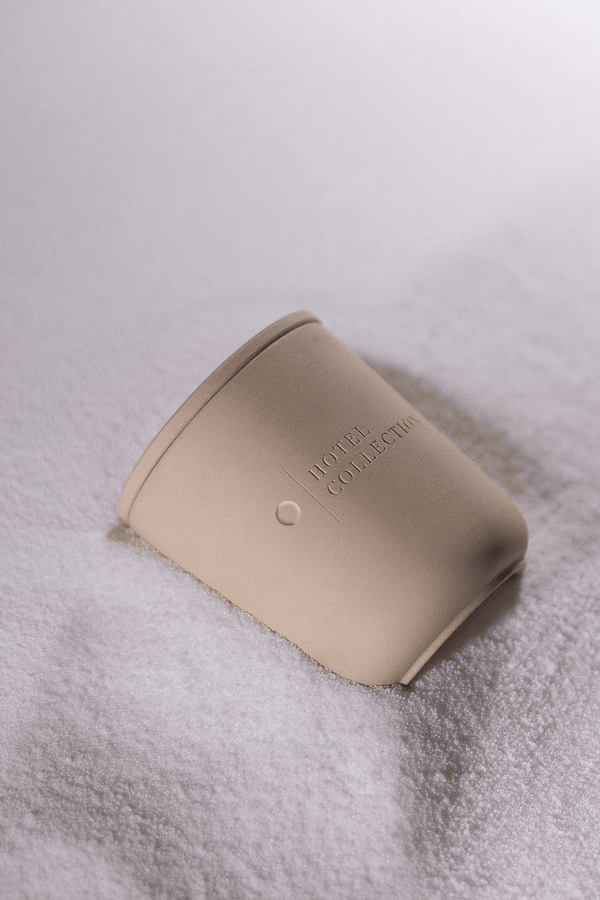 Beige container with 'Home Collection' text on a textured white surface