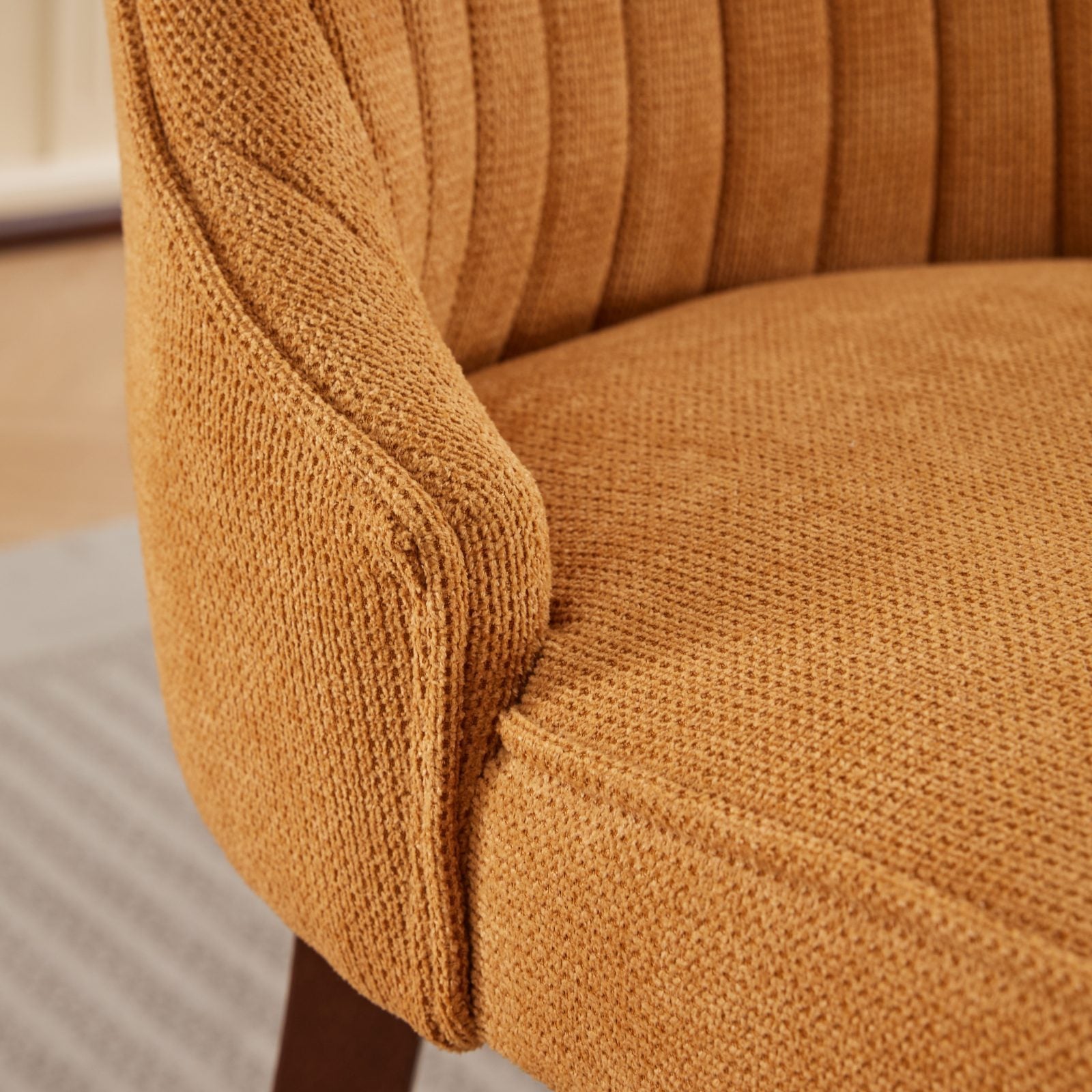 Armrest and seat stitching detail of the Set of 2 Rayon Cloth Flocking Linen Dining Chairs in textured mustard yellow fabric.