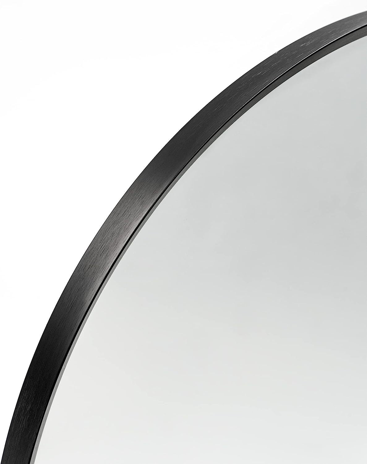 Detail of the arched top of the 24x36 Inch Black Metal Framed Wall Mirror, emphasizing the smooth curve and brushed black metal finish.