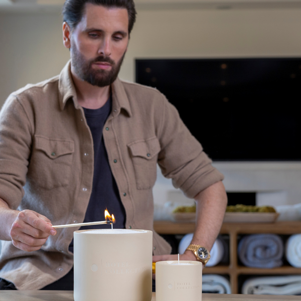 Man lighting a candle in a home setting