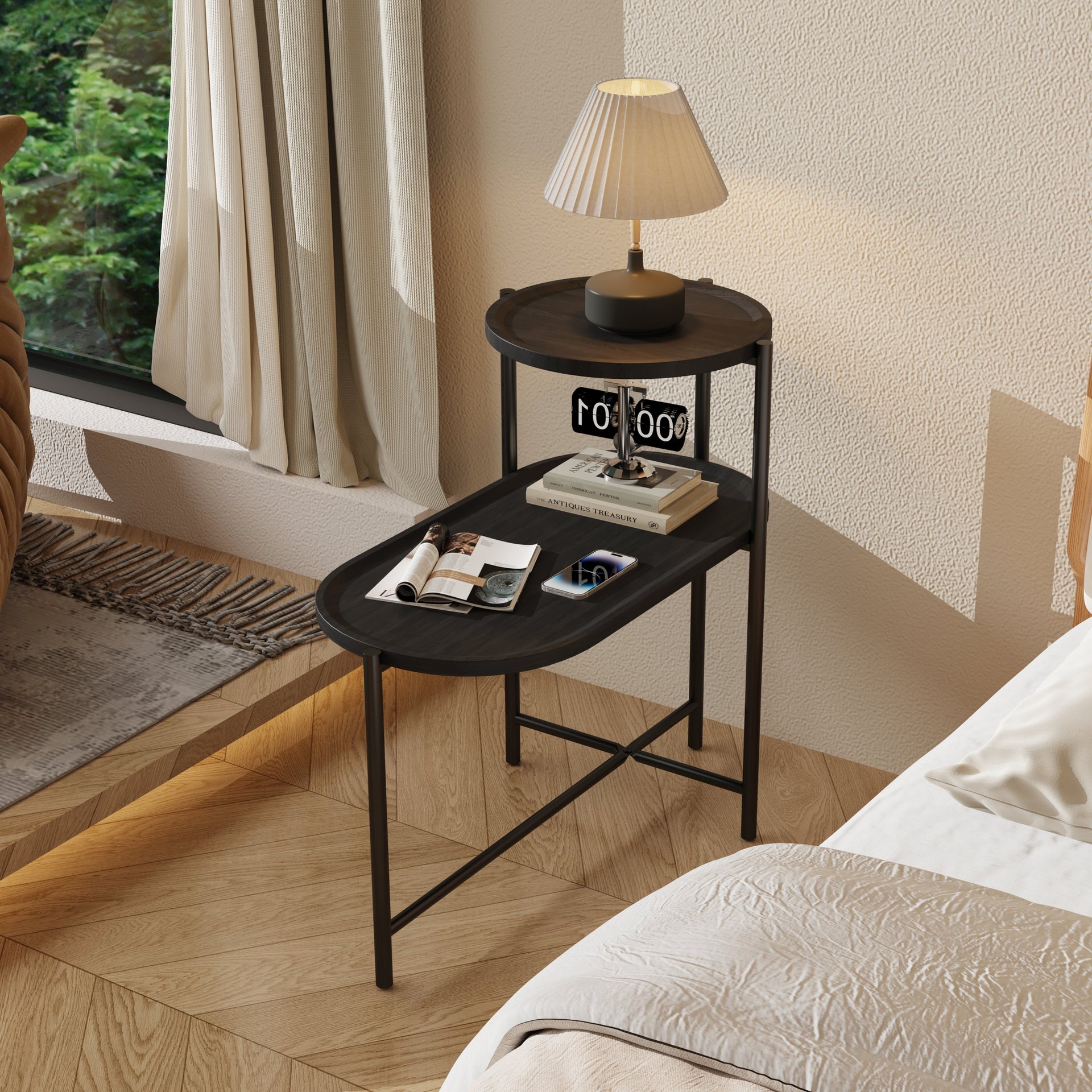 2 Tier Oval End Table with round top used as a nightstand, featuring a lamp and books in a cozy bedroom setting.