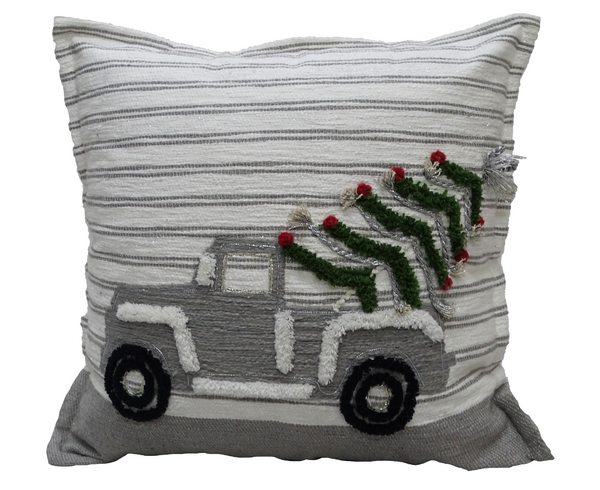 Decorative pillow with a truck and Christmas tree design on a striped background