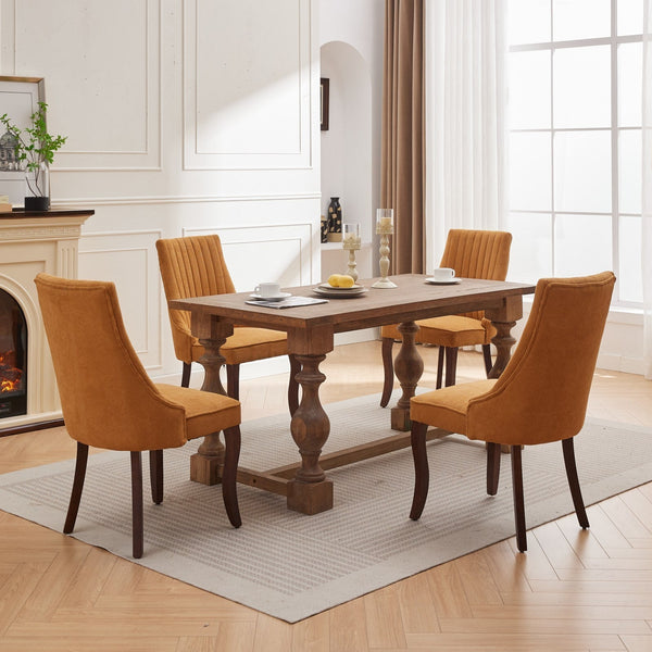 Four mustard yellow Rayon Cloth Flocking Linen Dining Chairs arranged around a rustic wooden dining table in a bright room.