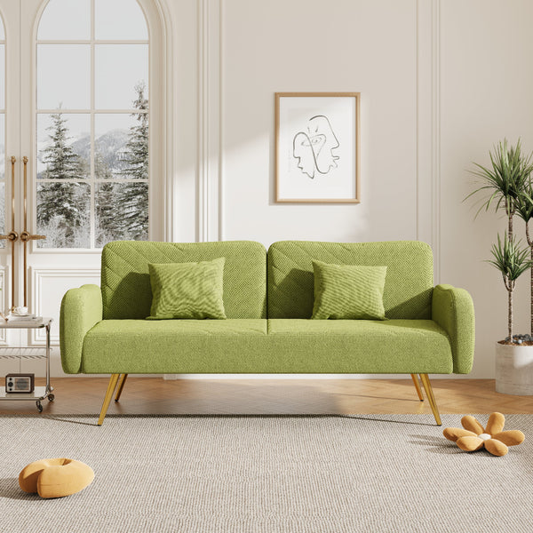 Green sofa in a living room with a window and decorative items.